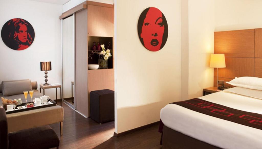 a hotel room with a bed and a desk at Villathena in Paris