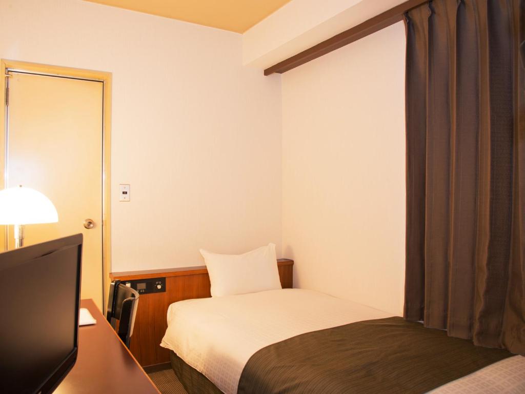 Postel nebo postele na pokoji v ubytování Hotel Abest Nagano Ekimae