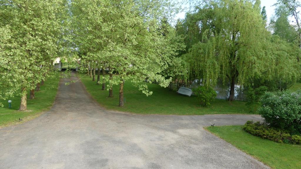 an empty driveway in a park with trees at Gite Guillemin in Le Deschaux