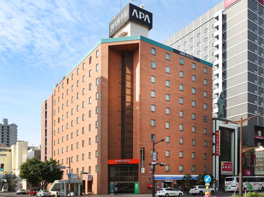 a building with a sign on the top of it at APA Hotel Sapporo Susukino Ekimae in Sapporo