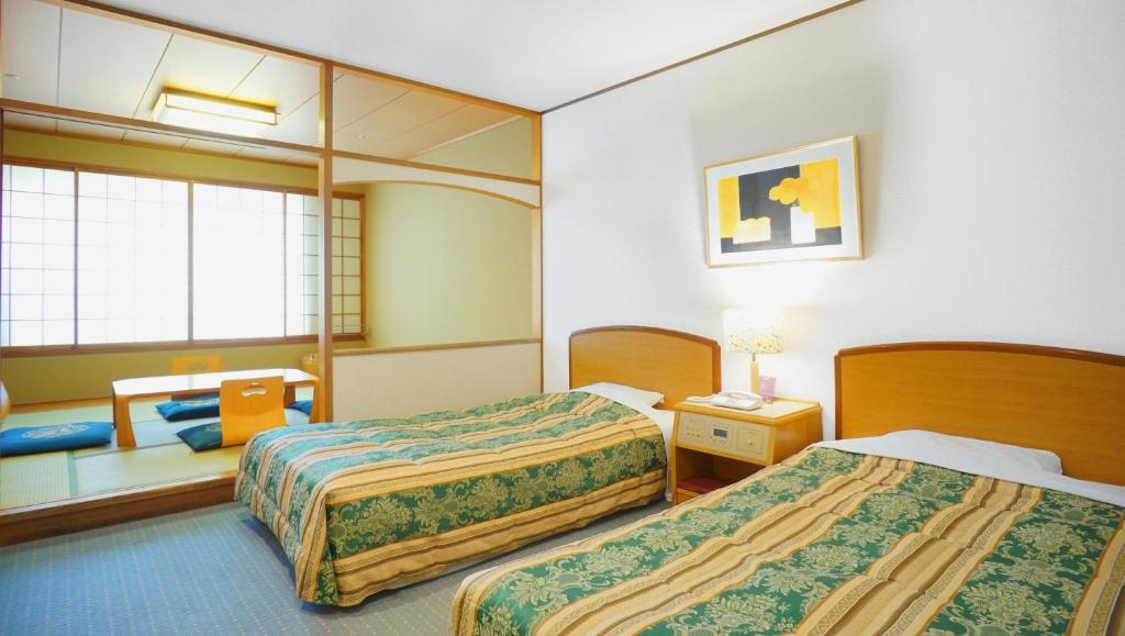 Postel nebo postele na pokoji v ubytování Hotel Laforet Nasu