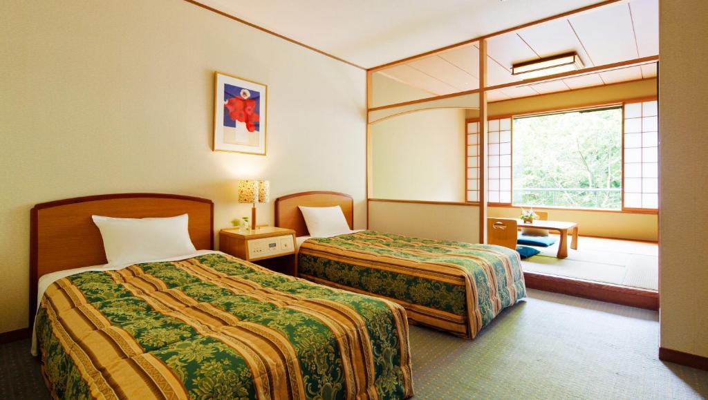 Postel nebo postele na pokoji v ubytování Hotel Laforet Nasu