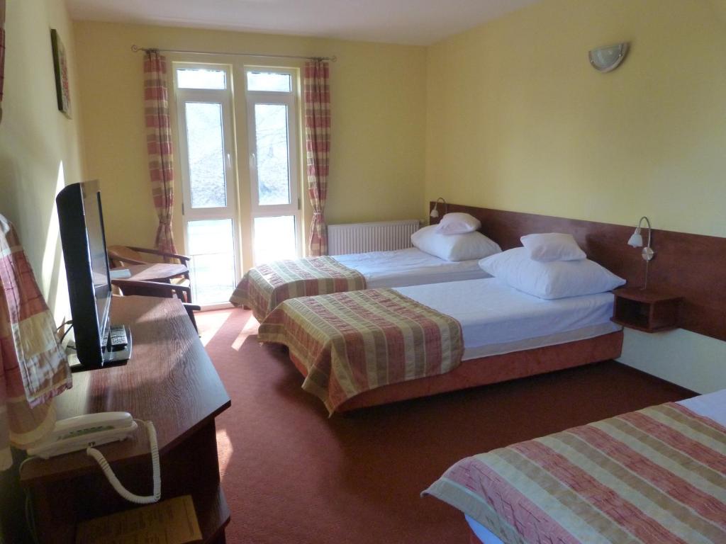 Postel nebo postele na pokoji v ubytování Hotel Kopernik