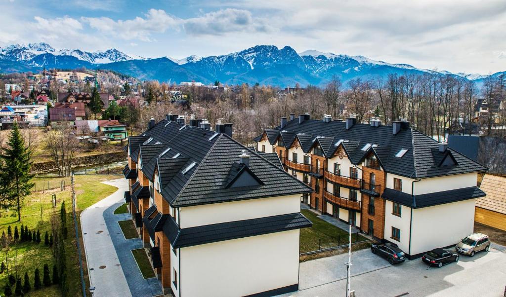 an aerial view of a building with mountains in the background at Apartamenty Forma Tatrica in Zakopane