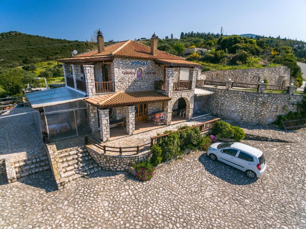 a white van parked in front of a house at Nireas : Stone Villa in Zakynthos