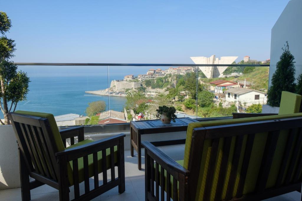 einen Balkon mit Stühlen und Meerblick in der Unterkunft Sunset Apartments in Ulcinj