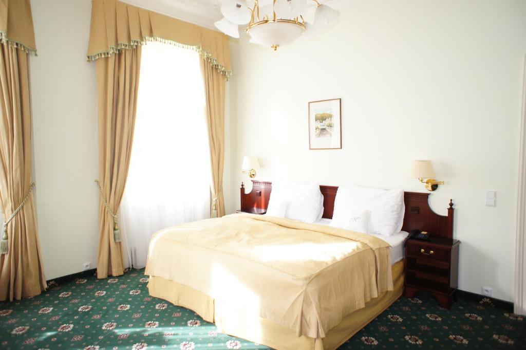 Postel nebo postele na pokoji v ubytování Hotel Mignon