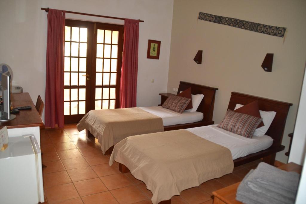 Postel nebo postele na pokoji v ubytování Guest House Orquidea