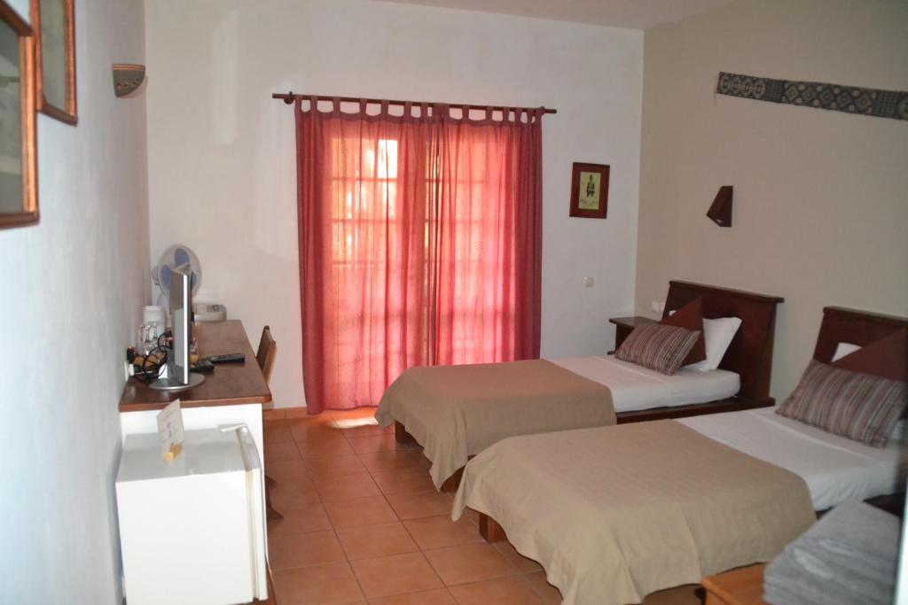 Postel nebo postele na pokoji v ubytování Guest House Orquidea