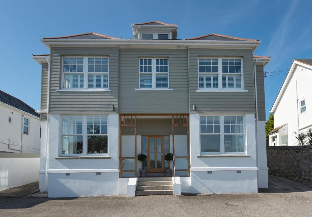 a house with a brown door on a street at Falmouth Bay in Falmouth