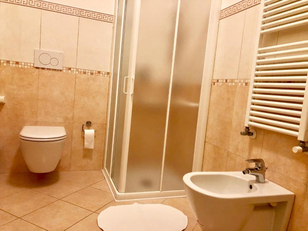 a bathroom with a shower and a toilet and a sink at Hotel Marte in Venice