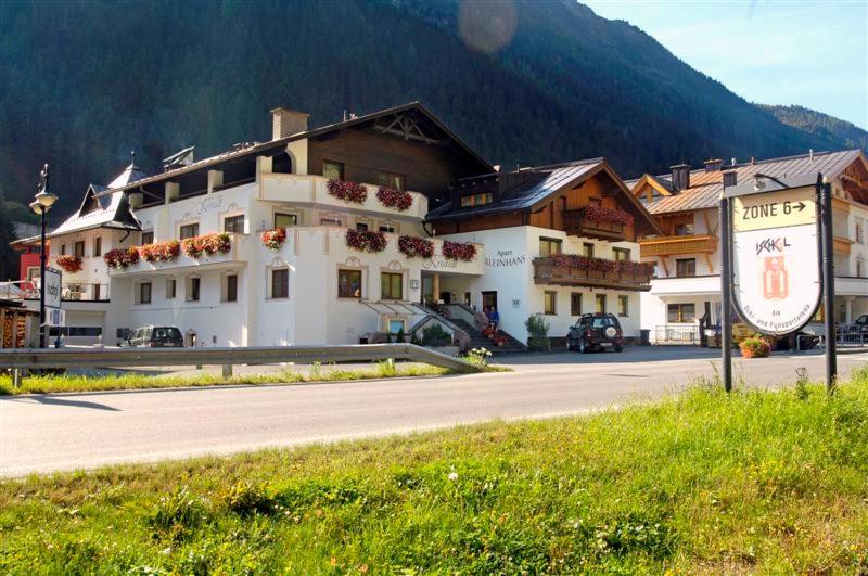 a large building on the side of a road at Hotel Kristall B&B in Ischgl