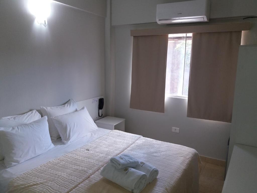 Postel nebo postele na pokoji v ubytování Madame Lynch Hotel Asuncion