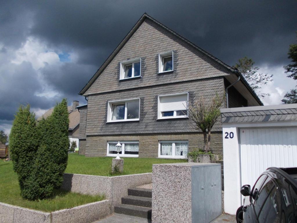 a gray house with white windows on a yard at Astentraum in Winterberg