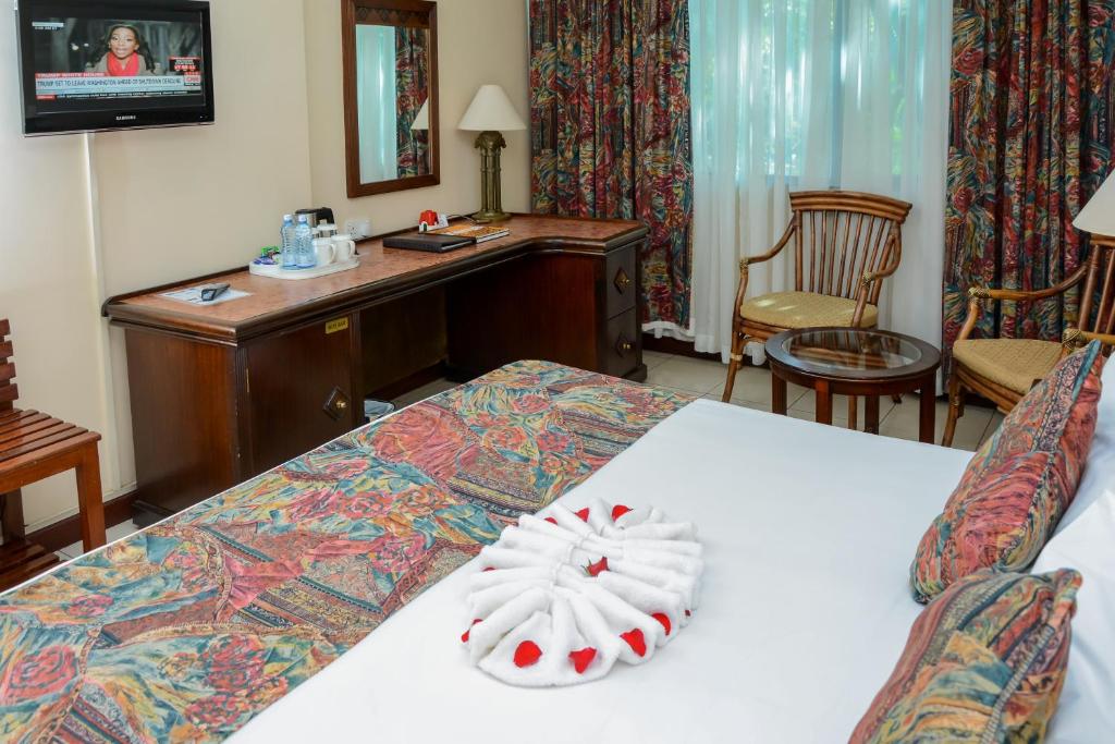 Postel nebo postele na pokoji v ubytování Jacaranda Hotel Nairobi