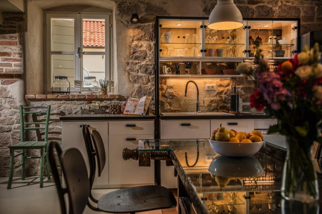 a kitchen with a bowl of fruit on a table at Villa Pauletta in Split