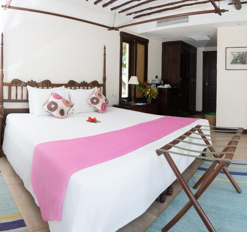 A bed or beds in a room at Jacaranda Indian Ocean Beach Resort
