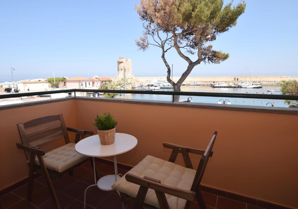 a table and chairs on a balcony with a view of the water at Lungomare in Marciana Marina