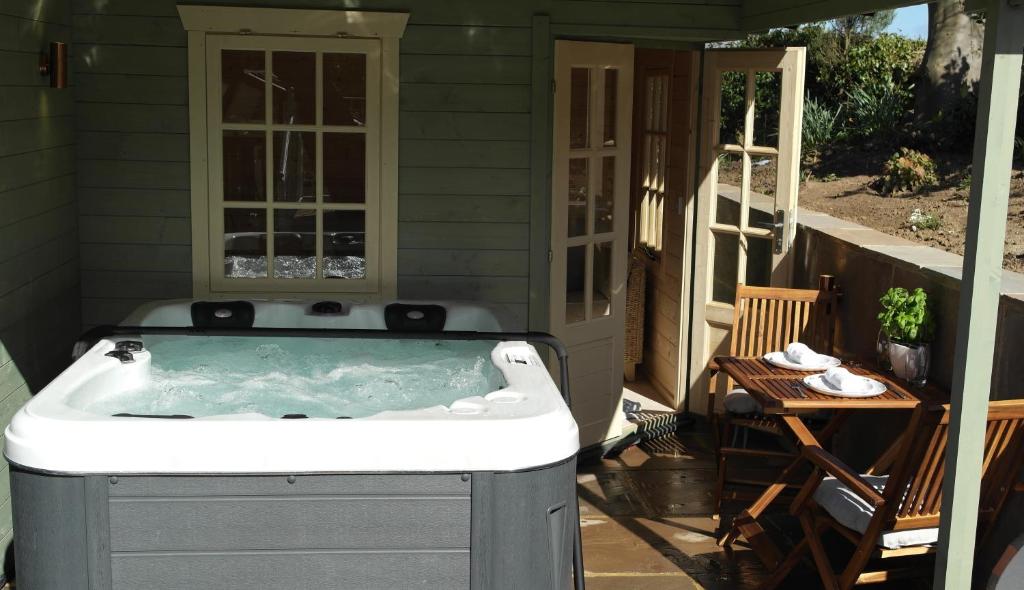 a hot tub on the patio of a house at Ashford house 'The Snug' private hot tub in Fylingthorpe