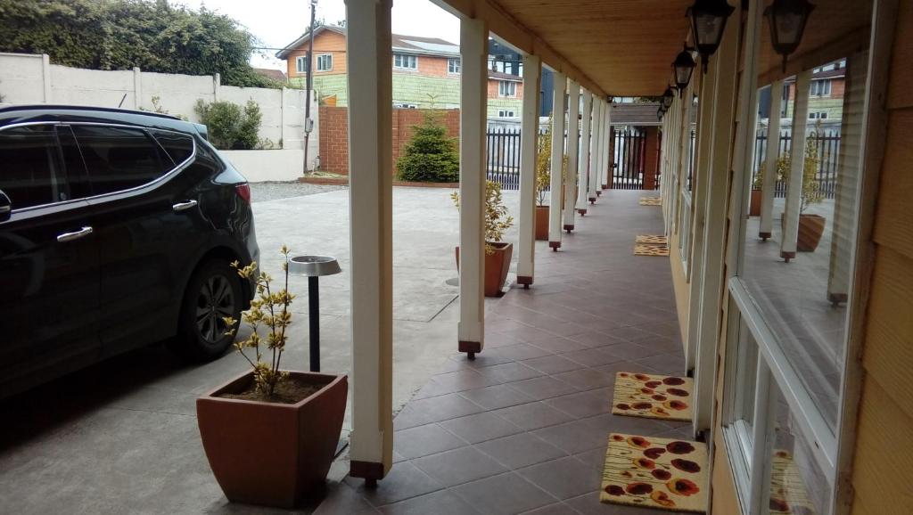 a hallway of a building with a car parked at Apart Hotel en Puerto Montt in Puerto Montt