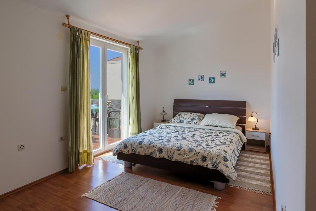 Posteľ alebo postele v izbe v ubytovaní Apartment Monica