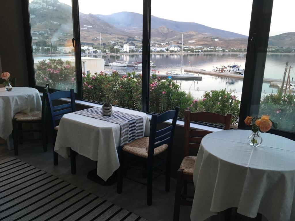 a restaurant with two tables and a view of a marina at Cristi Rooms in Livadi