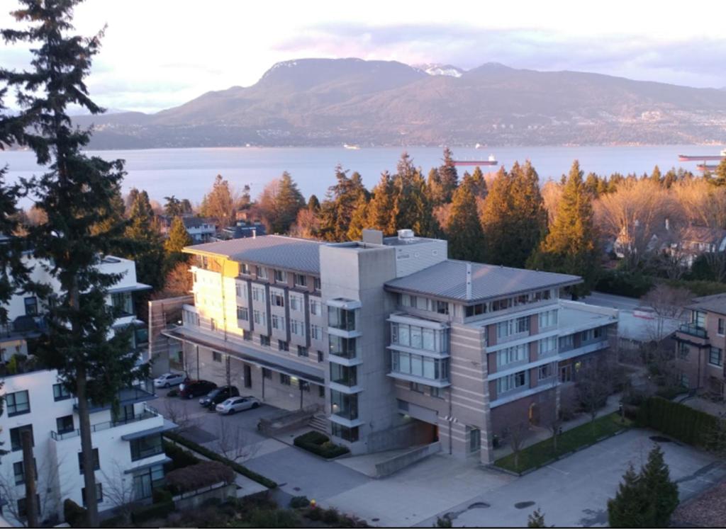 an aerial view of a building in front of a lake at Carey Centre on UBC campus in Vancouver