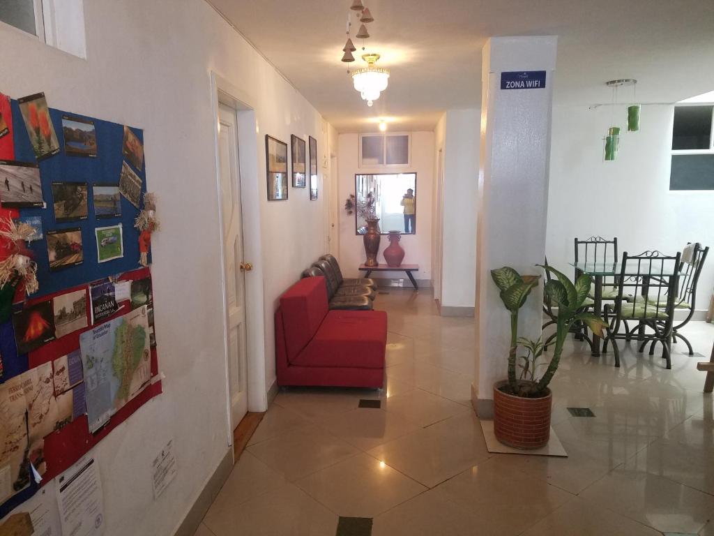 a hallway with a red couch in a room at Hotel Ventura in Riobamba