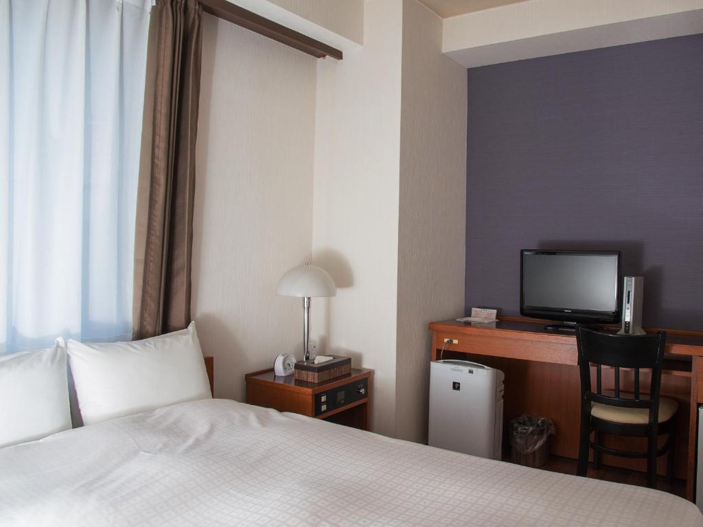 Postel nebo postele na pokoji v ubytování Hotel Abest Nagano Ekimae