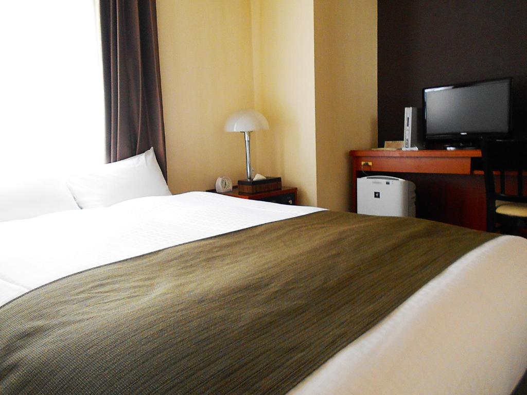Postel nebo postele na pokoji v ubytování Hotel Abest Nagano Ekimae