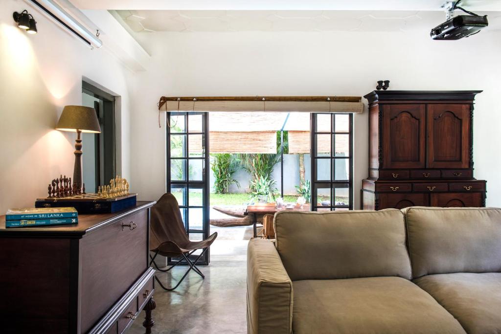 a living room with a couch and a table at The Cottage Bentota in Bentota