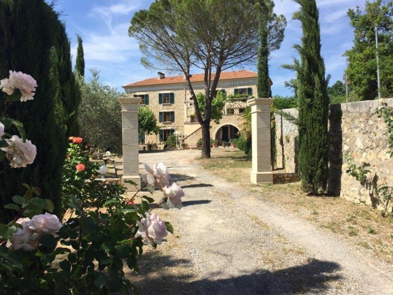 a large house with a tree and a driveway at Hôtel du Moulin in Allemagne-en-Provence