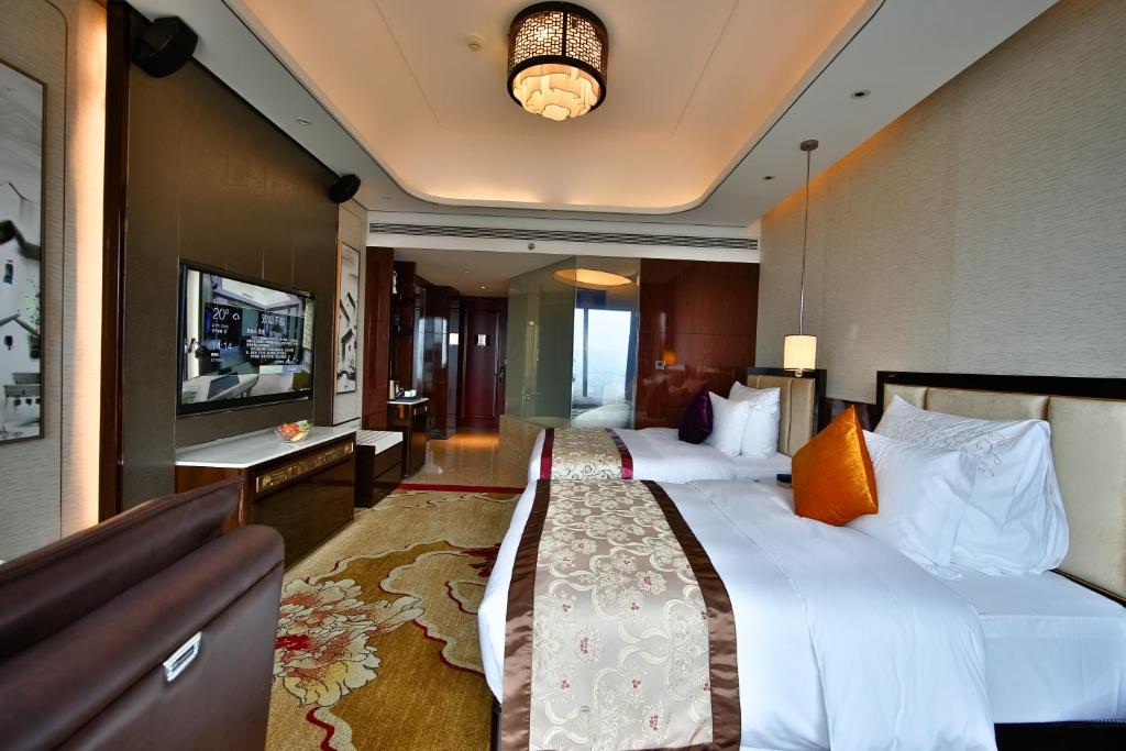 Postel nebo postele na pokoji v ubytování Chengdu CYNN Hotel