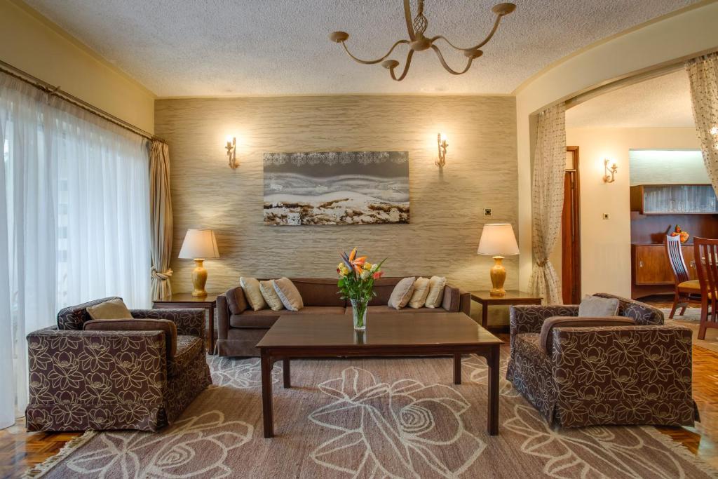 a living room with a couch and a table at Mimosa Court Apartments in Nairobi