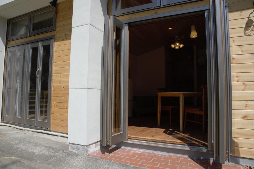 a sliding glass door on the side of a building at Mountain Home Lodge in Deer Park in Nara