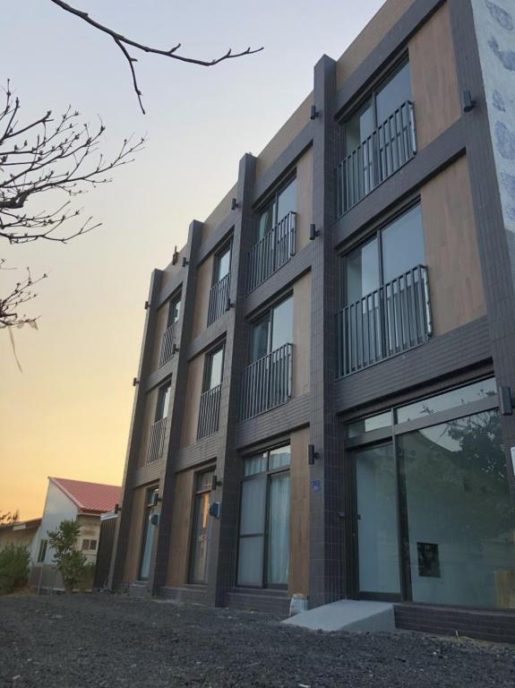 a large building with windows on the side of it at Kenting Peninsula Inn in Kenting