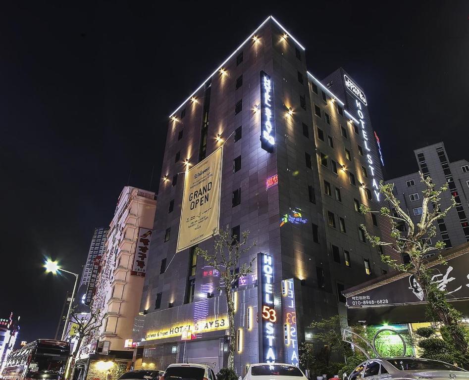 a tall building with lights on it at night at Hotel Stay 53 in Gwangju