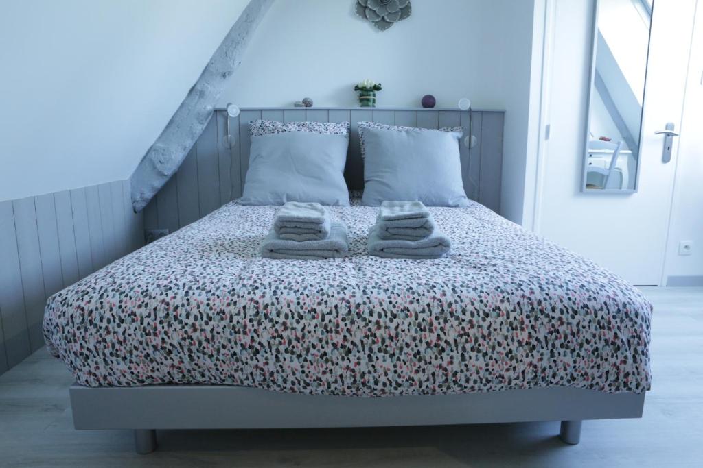 une chambre avec un lit avec des serviettes dessus dans l'établissement Le Clos d'Esquay, Côté Seulles, à Esquay-sur-Seulles