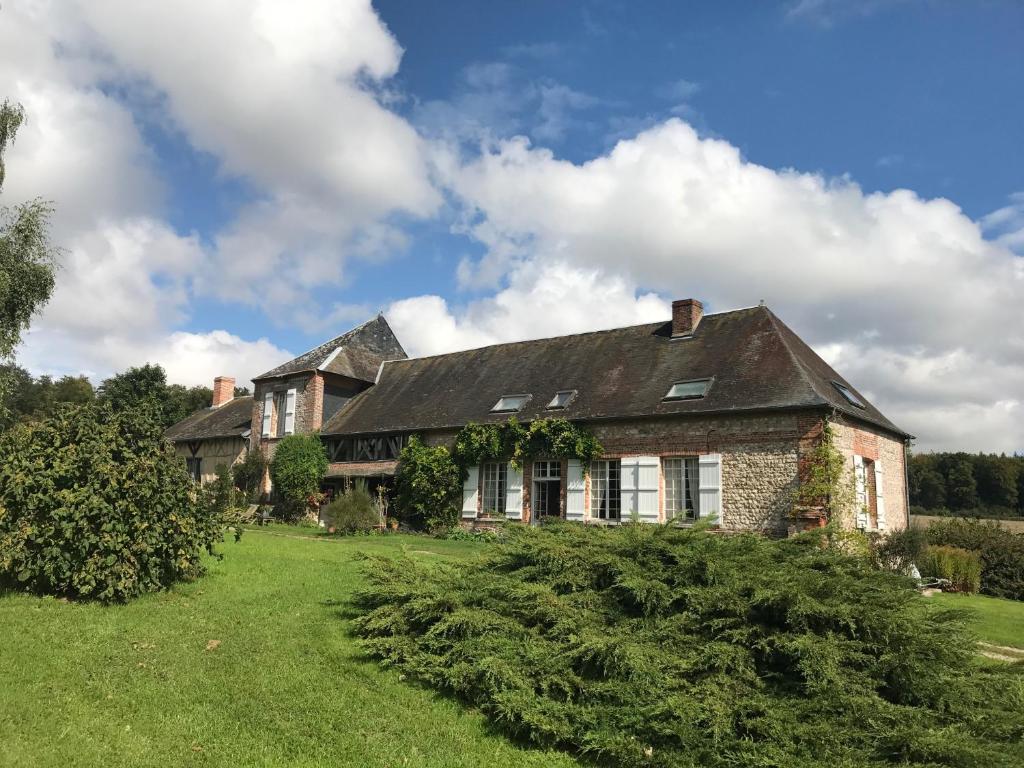 an old brick house with a green yard at Ferme de la Haye in Montroty