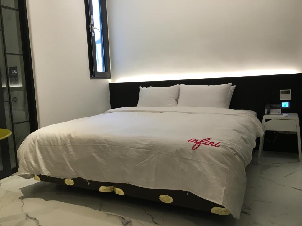 Postel nebo postele na pokoji v ubytování Hotel Infini
