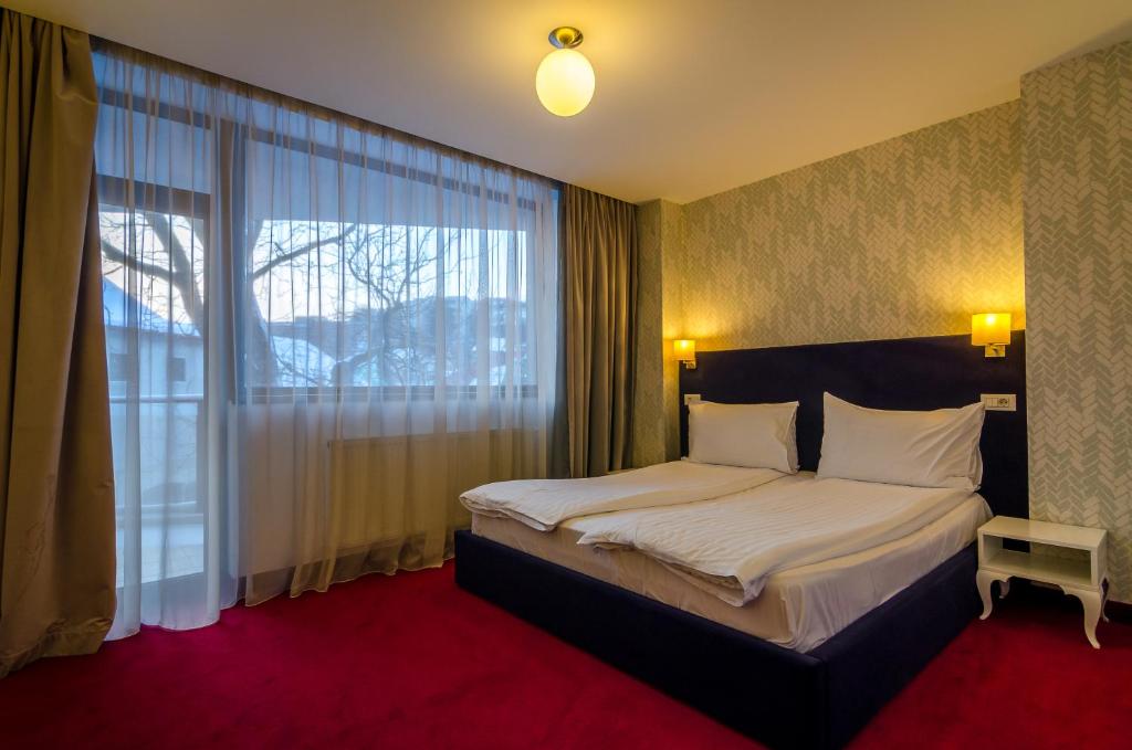 En eller flere senger på et rom på Apart Hotel Vlad Tepes