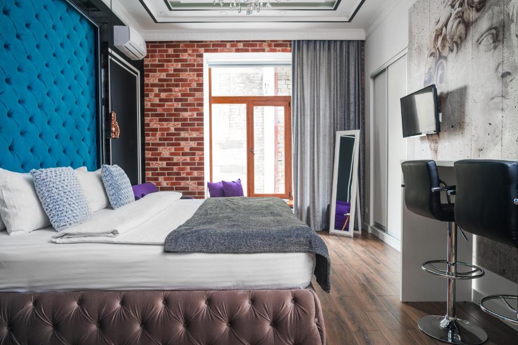 Postel nebo postele na pokoji v ubytování Theatre Boutique Apartments