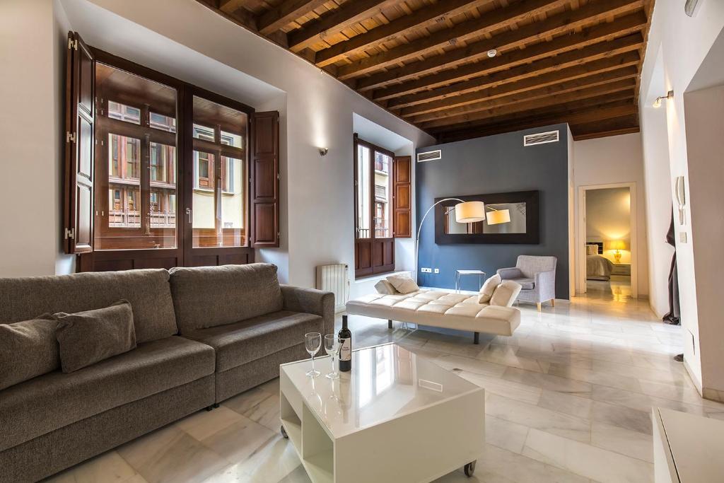 a living room with a couch and a coffee table at Elvira Suites in Granada