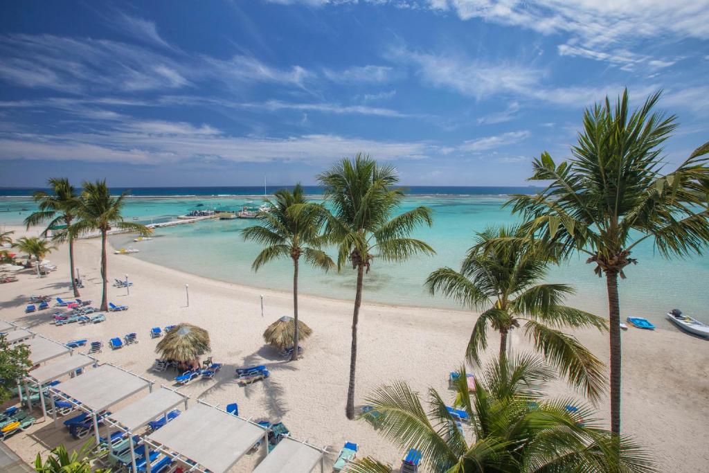 an aerial view of a beach with palm trees and the ocean at Hotel whala!boca chica - All Inclusive in Boca Chica