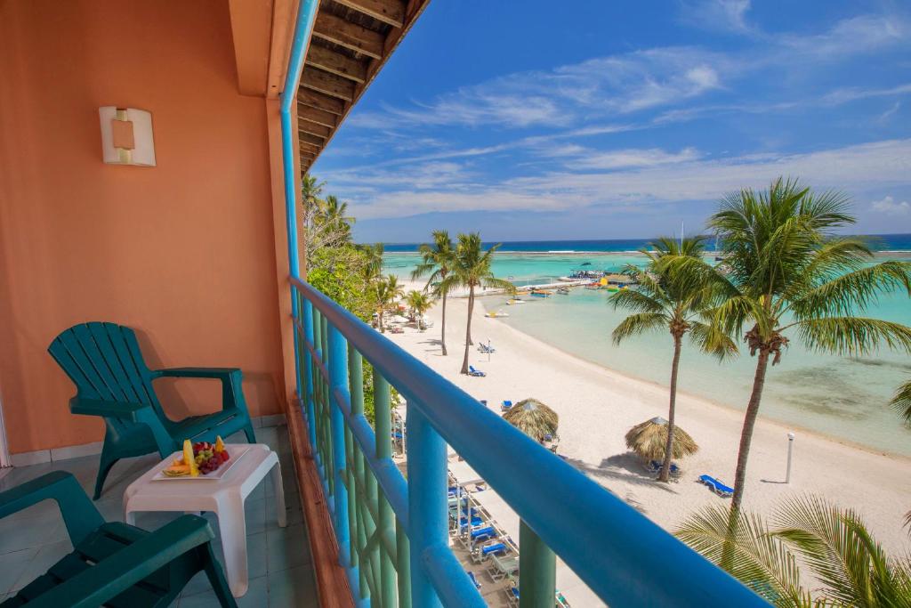 a balcony with a view of the beach and ocean at Hotel whala!boca chica - All Inclusive in Boca Chica