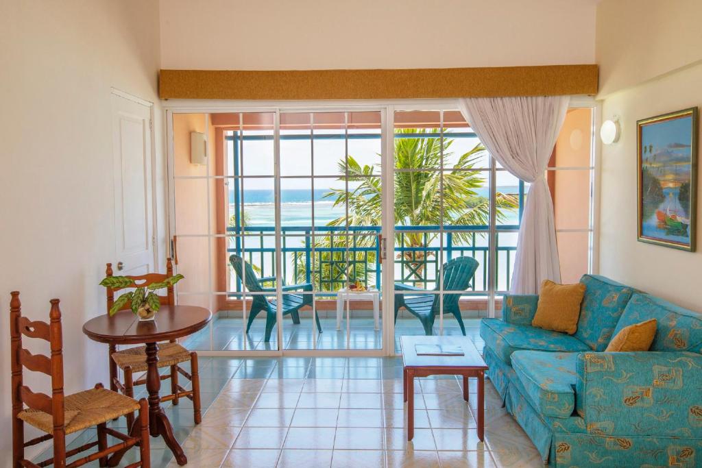 a living room with a blue couch and a table at Hotel whala!boca chica - All Inclusive in Boca Chica