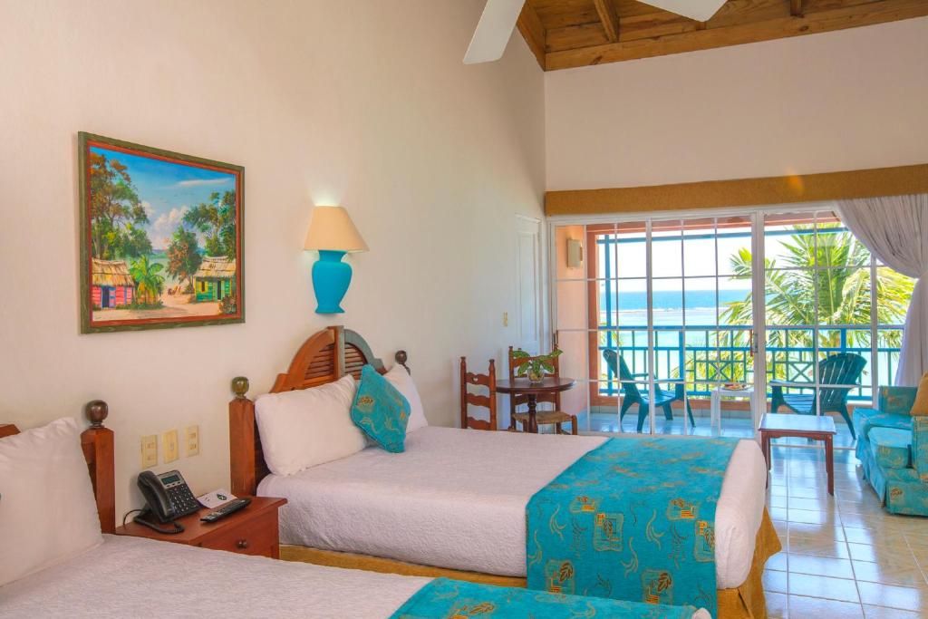 a bedroom with two beds and a view of the ocean at Hotel whala!boca chica - All Inclusive in Boca Chica