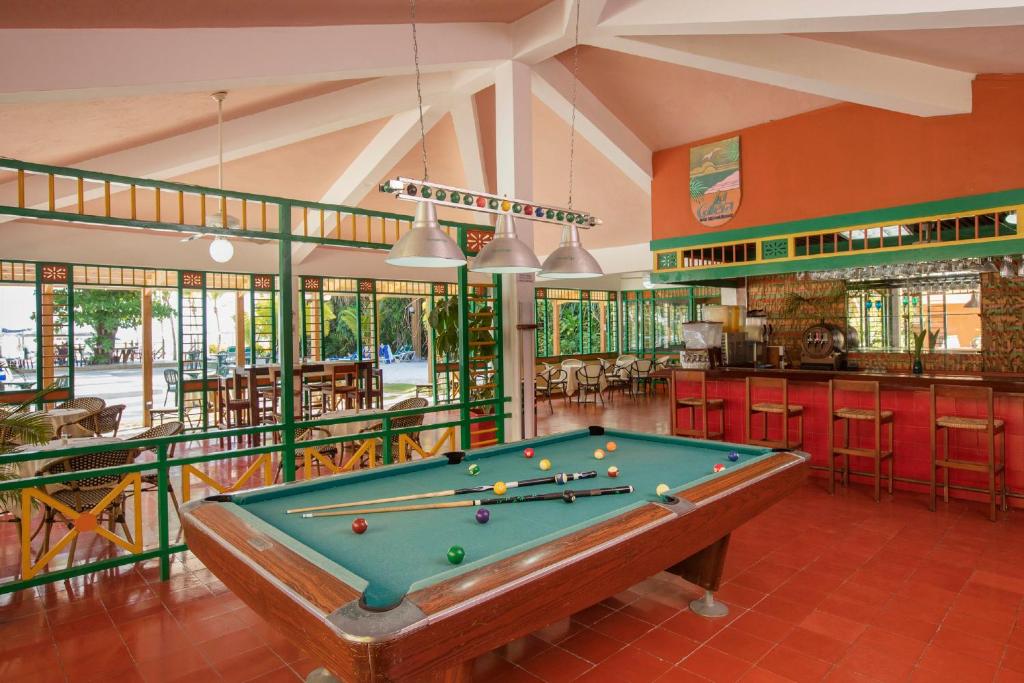 a pool table in a room with a bar at Hotel whala!boca chica - All Inclusive in Boca Chica