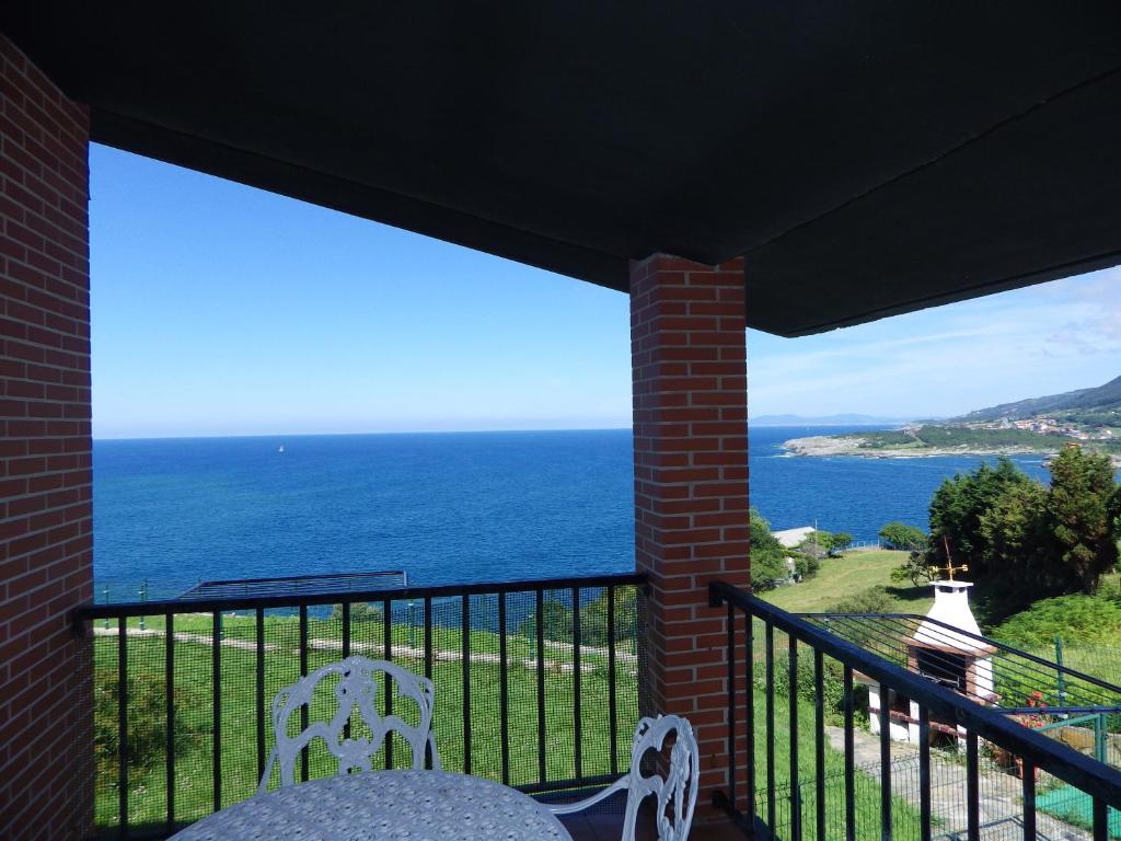 a balcony with a view of the ocean at Villa La Ballena de Sonabia in Oriñón