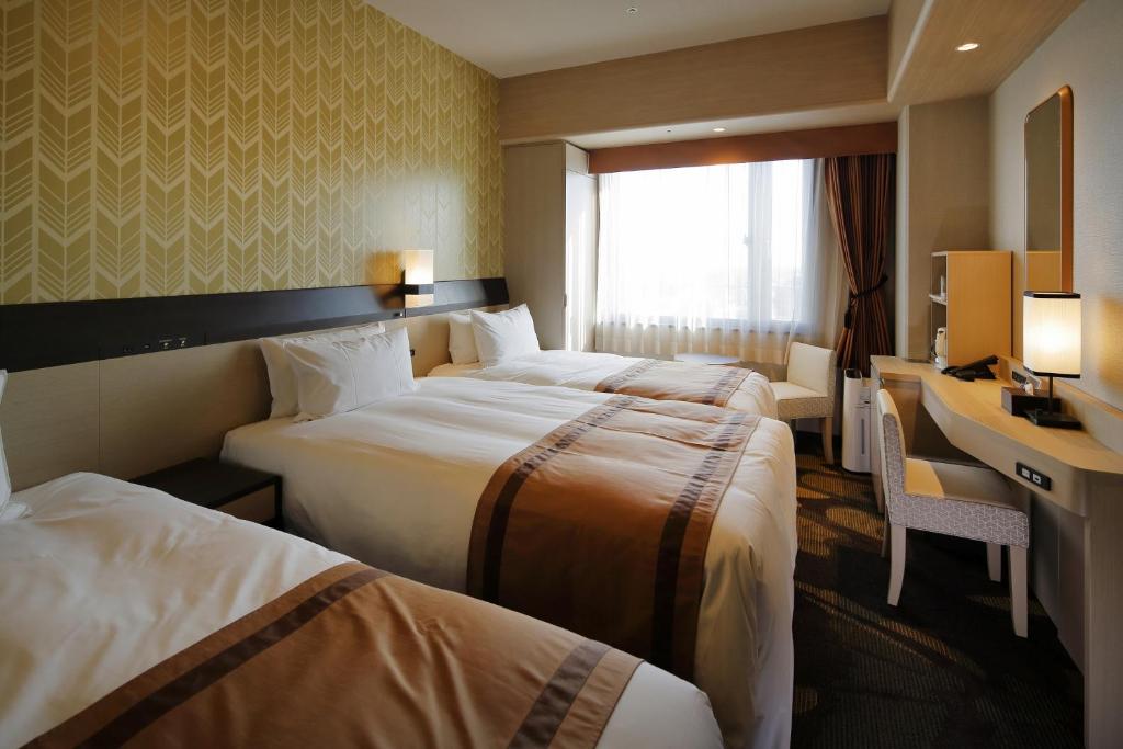 Postel nebo postele na pokoji v ubytování Hotel Monterey Himeji